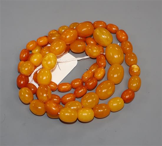 A single strand graduated oval amber bead necklace, gross weight 69 grams,